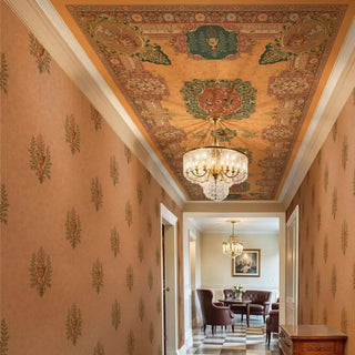 A European-style wallpaper featuring delicate buti-inspired floral motifs on warm brown walls, complemented by an ornate patterned ceiling mural and chandelier in a hallway.