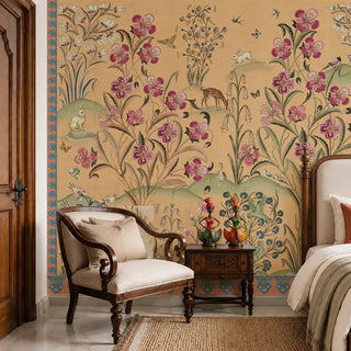 Petals of Persia wallpaper in Antique Sand beside an armchair and bedside table, showing magenta blooms, a spotted fawn and decorative border detail.