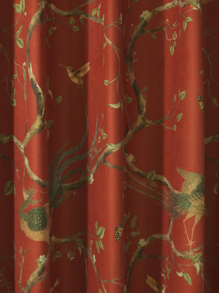 Close-up detail of the phoenix and hummingbird motifs on the terracotta red fabric of the Chinoiserie curtain.