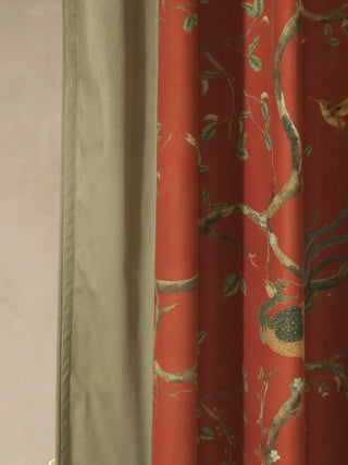 A detailed side-view showing the contrast between the illustrated red panel and the sage green velvet curtain border.