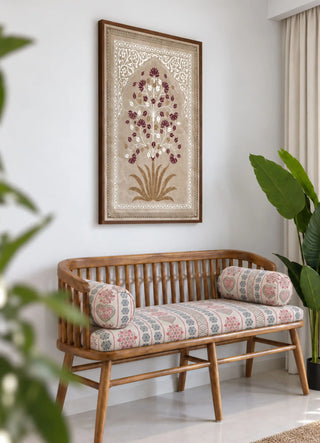 The Pietra wall art in Taupe & Wine framed above a slatted wooden bench with patterned bolster cushions and potted plants.