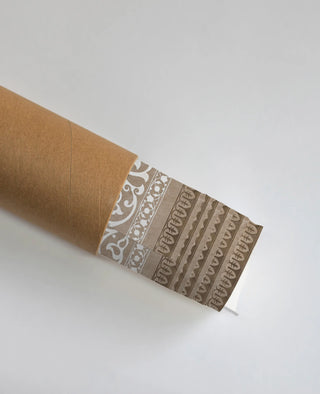 The Pietra wall art in Taupe & Wine shown rolled and packaged in a protective kraft shipping tube.
