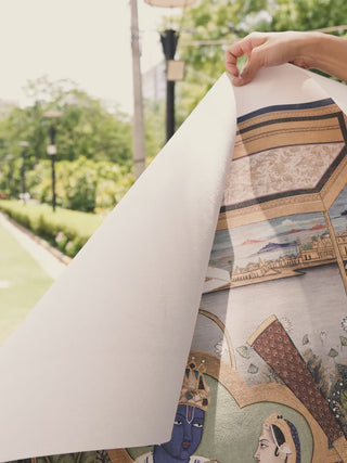 Video of Ram Darbar embroidered wall art in indigo, saffron and gold, showing seed pearl and zardozi detailing on Ram and Sita enthroned beneath the canopy