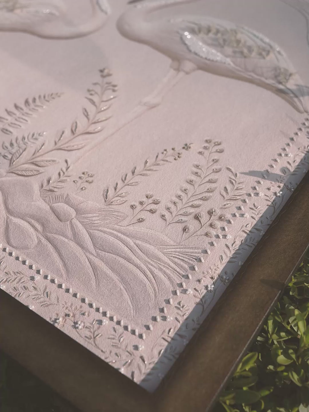 Video of Sculpted Song embroidered wall art showing tone-on-tone raised needlework across the botanical composition