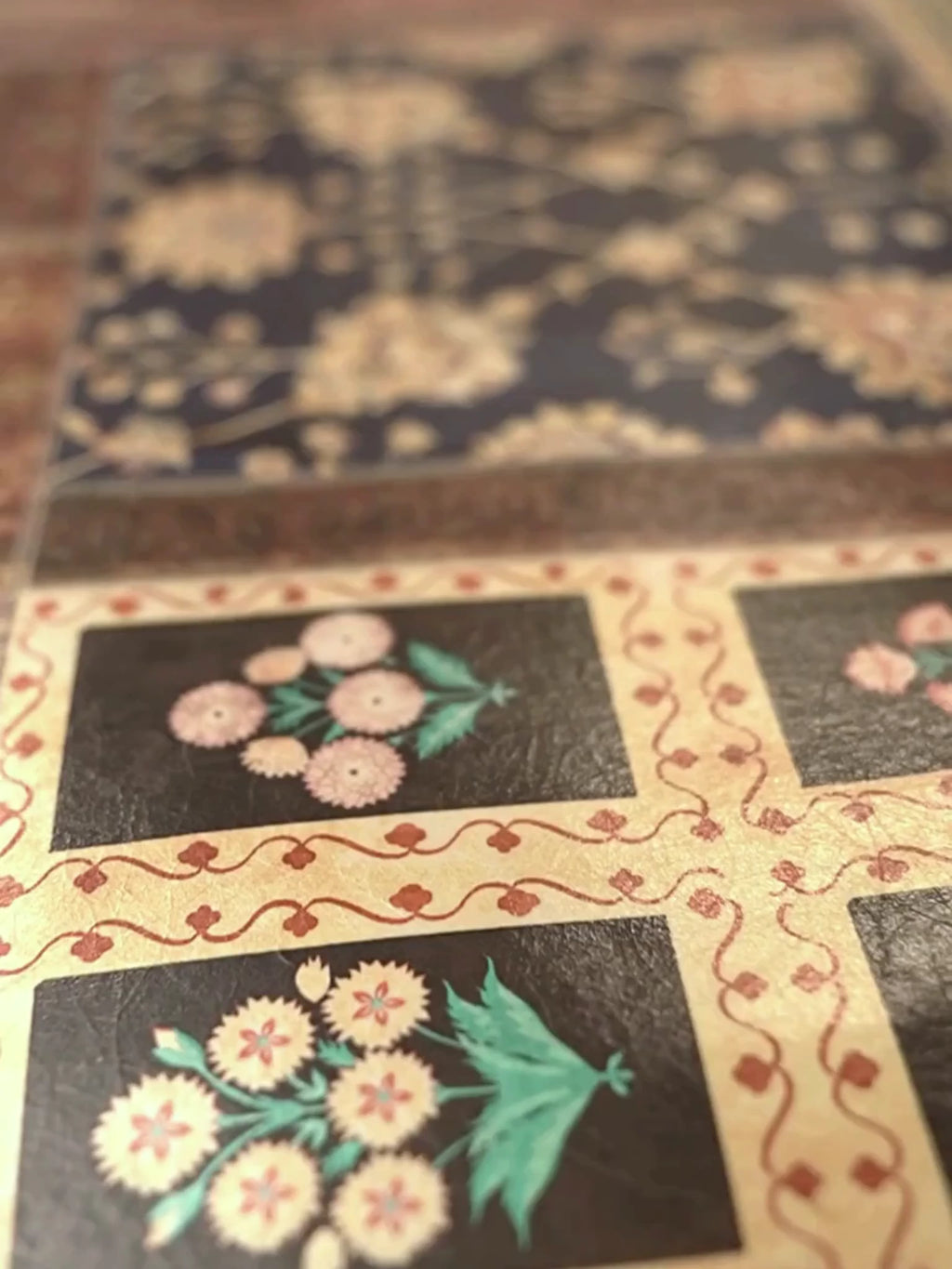 Close-up video of the Aalishan landscape wall art, moving across its antique carpet panels, floral medallions, a prayer-niche arch and rug borders