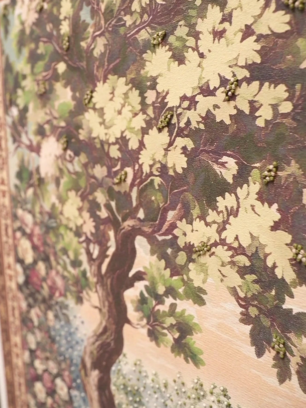 Close-up video of the Garden of Tunes embroidered wall art, moving over beaded tree canopies, the floral border, a harpist, string player and flutist