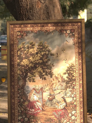 Video of Garden of Tunes embroidered wall art in burgundy, forest green and sky blue, showing needlework on the harpist, flutist and rose garden beneath towering oaks