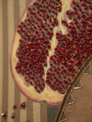 Gilded Mythos embroidered wall art: a beaded pomegranate in deep red, the goddess with a pearl necklace and a basket, on a striped ground