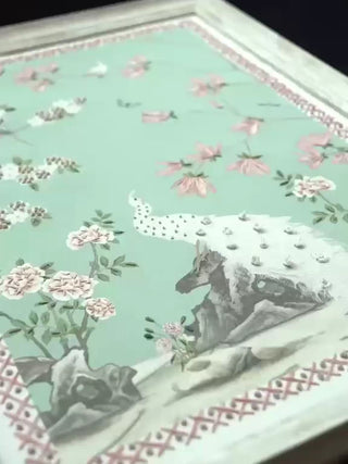 Grace Embrace embroidered wall art on a mint ground: a beaded white peacock, pink blossoms and a small blue and yellow bird on a branch