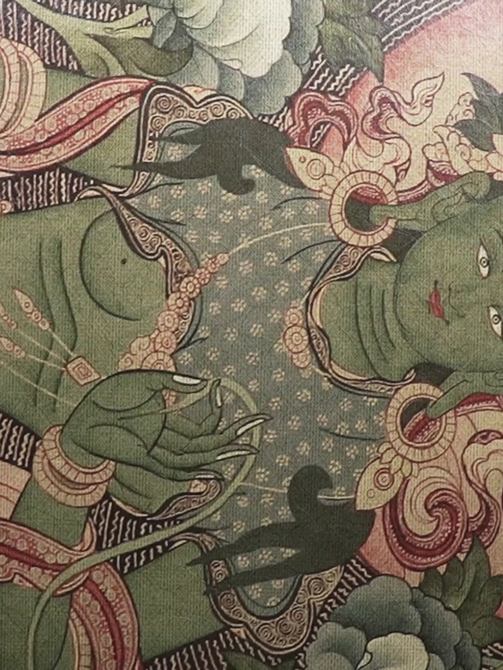 Close-up video of the Green Tara wall art in green and yellow, moving over Tara’s face and jewelled hands, white peonies and pink lotus blooms