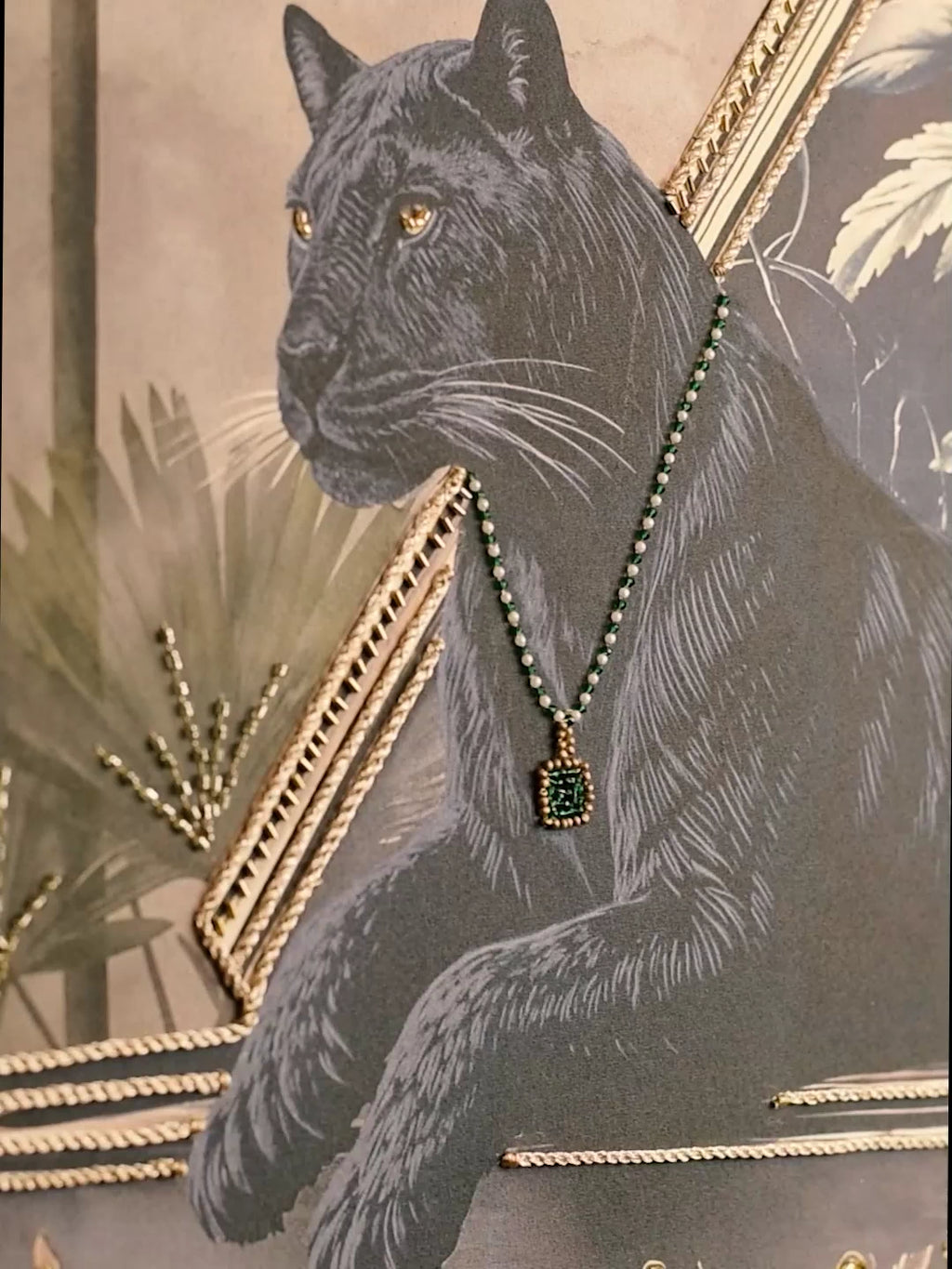 Jungle Noir embroidered wall art: a black panther wearing an emerald and pearl necklace, with gold braid, palm fronds and floral detail