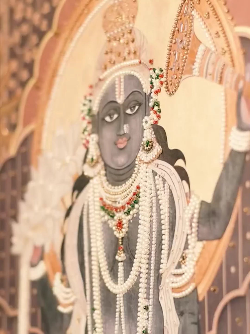 Shyam Sundar embroidered wall art video: Shrinathji adorned with pearl garlands, a cow and lotus details in charcoal and terracotta tones
