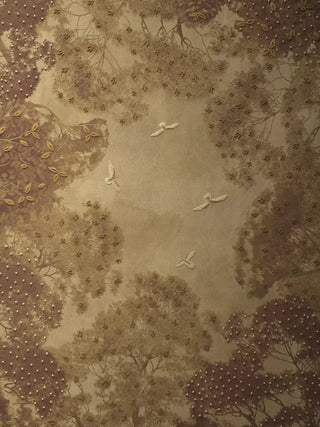 The Forest Nest embroidered wall art: a towering canopy of trees with small birds in flight, gold leaf details, the beaded border and pearl trees
