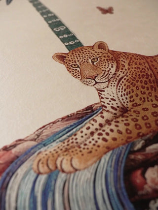 Close-up video of The Royal Jungle Safari wall art, moving over a leopard resting on textile-patterned hills, a waterfall and palm fronds