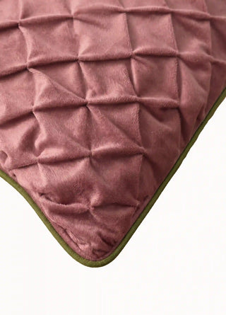 Close-up of the Prism Lattice cushion cover in dusty rose, showing the pinched diamond texture and olive green piping.