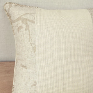 A macro view of the hand-guided whipstitched cord boundary and printed branch fabric on the corner of the Prose Pattern pillow.
