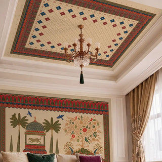 Qarina ceiling mural in crimson, teal and parchment applied to a white tray ceiling in a formal drawing room with a crystal and gilt chandelier at centre, coordinating Rajasthani wall mural below, cream curtains, and jewel-toned velvet cushions