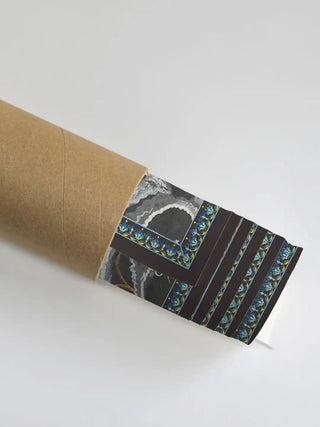 Close up of the Radha Krishna mural's intricate borders and charcoal texture in a protective shipping tube.