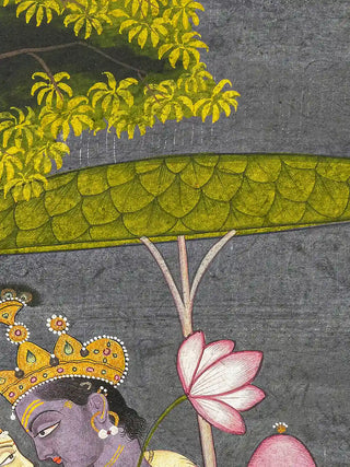 A detailed close-up of the Radha Krishna wall art highlighting a leaf parasol and lotus blossom above the crowned figure.