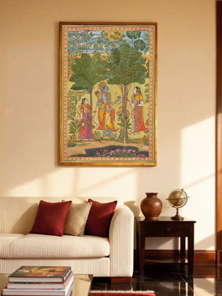The Raga Rama wall art in a gold frame displayed above a cream contemporary sofa in a luxury living room.