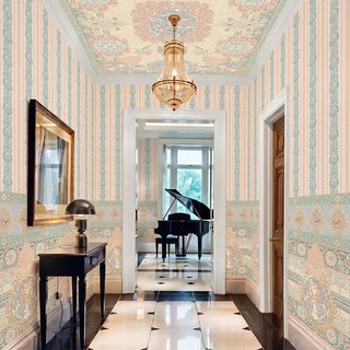 The Rahnuma ceiling mural in Dusty Rose & Gold installed above a striped feature wall in an entryway, with a chandelier hanging at the centre medallion. view-ceiling