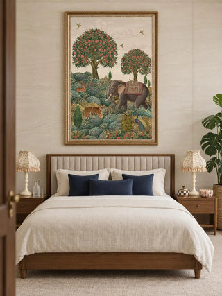 The Rajasi Van wall art in a gilded frame above an upholstered channel-tufted bed with navy cushions and fringed floral lamps.