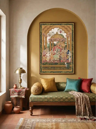 Framed Ram Abhishek embroidered wall art in a golden arched alcove above a green upholstered daybed