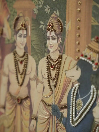 Close-up of hand-beaded necklaces and gold detailing on Lord Ram and attendant figures in the Ram Abhishek design