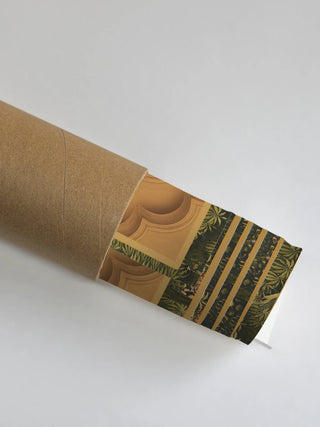 The Ram Abhishek wall art partially unrolled from its kraft paper shipping tube, showing the golden arch and green foliage border.