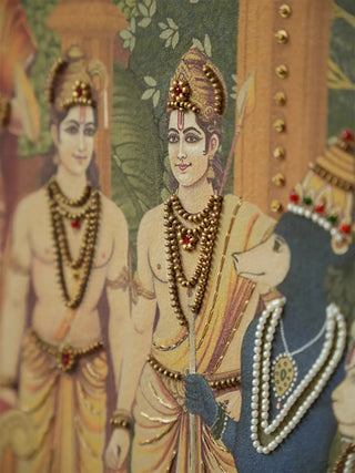A high-resolution close-up of the raised gold embroidery and jewel work detailing on the crowns and jewelry of the royal figures.