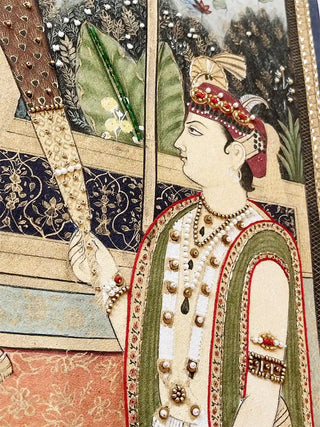 Close-up of embroidered attendant figure with beaded headpiece and floral embellishment in the Ram Darbar design