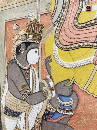 Close-up of hand-beaded Hanuman figure with gold crown detailing in the Ram Darbar design
