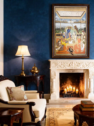 Ram Darbar embroidery-style mural displayed above a white marble fireplace in a luxury living room.