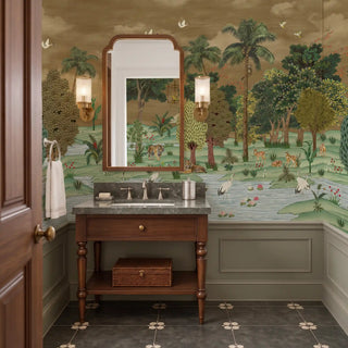 Ran Shringar wallpaper depicting Ranthambore Forest in Muddy Brown as a full-wall backdrop behind a caned sofa and armchairs in a living room.