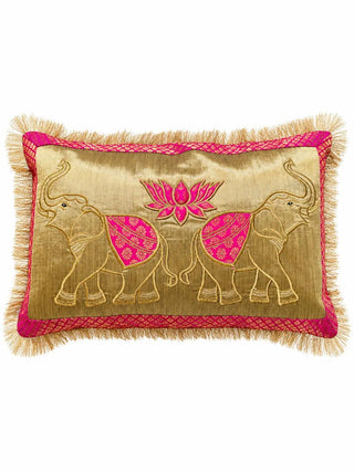 The Rangrez lumbar cushion cover showing two gold-embroidered elephants facing a pink lotus on a gold ground, with a pink brocade border and fringe.