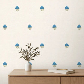A serene study setting featuring the Rani floral wallpaper behind a modern oak desk with neutral books and a white vase.