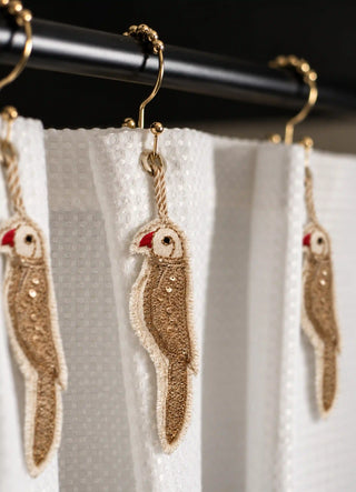 The Ranjha charm in Ivory & Gold, view-detail of the gold sequin body and frayed linen edge.