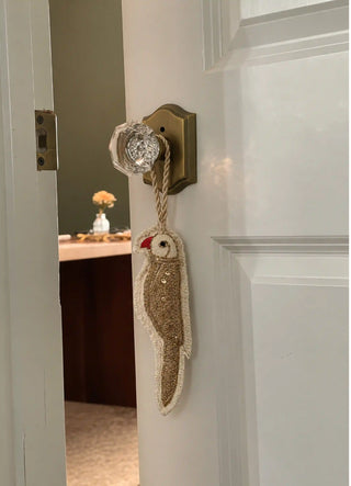 The Ranjha charm in Ivory & Gold, view-doorknob hanging from a crystal-and-brass knob.