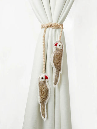 Close-up of two hand-embroidered Ranjha parrots with gold sequins and red beaks