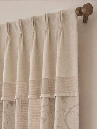 A detailed upper-angle view of The Reed Rhythm curtain displaying its neat pinch-pleats, mesh insert band, and custom dark walnut wood rod.