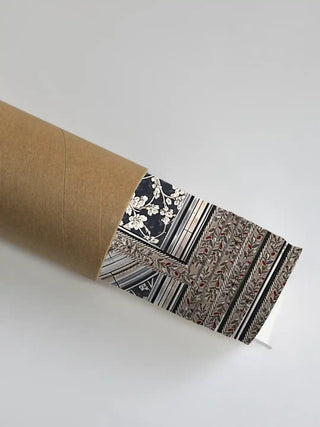 Premium embroidered wall art safely tucked inside a heavy-duty cardboard shipping tube for secure transit