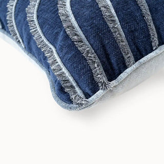 Close-up of the navy cushion corner showing the silver fringed wave detail.