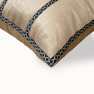 Close-up of the beige cushion corner showing the patterned stripe detail and piping.