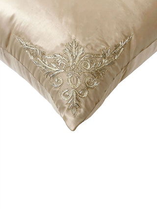 Close-up macro detail of Rocaille Charm cushion cover highlighting intricate metallic gold acanthus leaf corner threadwork.