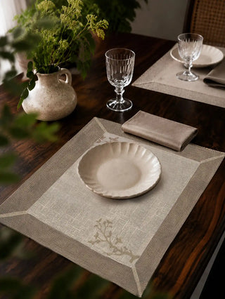 Rooted Grace cream mats with sage branch embroidery set with white plates and crystal glassware