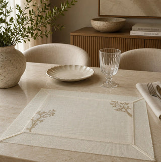 A high-resolution close-up of the open-weave ivory canvas grid and hand-guided taupe tree branch embroidery on the Rooted Grace runner.