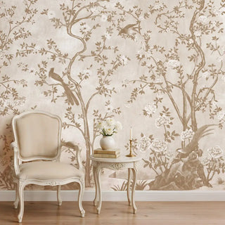 Elegant Rosa Chinoiserie wallpaper with twisting branches and birds in a cozy reading corner with a classic armchair.