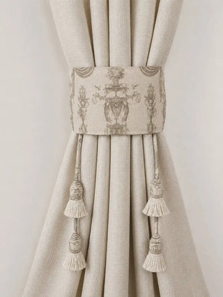 A symmetric front-facing shot of the Rosette Royale toile-printed linen curtain tieback holding uniform vertical drape folds.