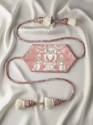 A flat-lay view of the Rosette Royale tieback showing the full length of the cord and the printed velvet band.