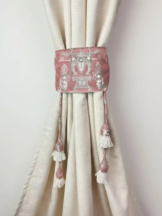 The Rosette Royale tieback styled on a textured ivory linen curtain, highlighting the contrast of the rose velvet.